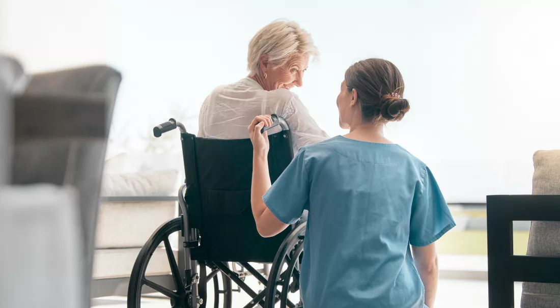 old-woman-wheelchair-care-caregiver-talking-healthcare-support-nursing-home-back-view-happy-nurse-speaking-senior-patient-elderly-person-with-disability-empathy-hope