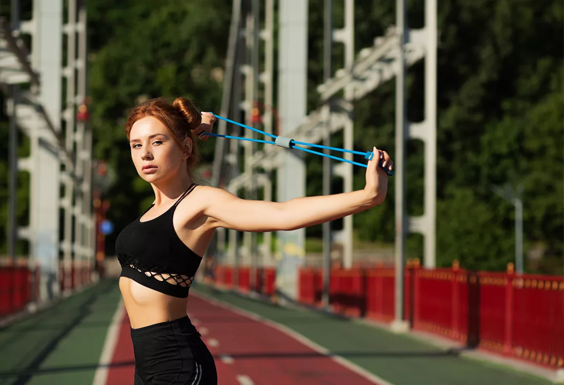 gorgeous-athletic-red-haired-girl-doing-stretching-workout-bridge-sunny-morning-space-text